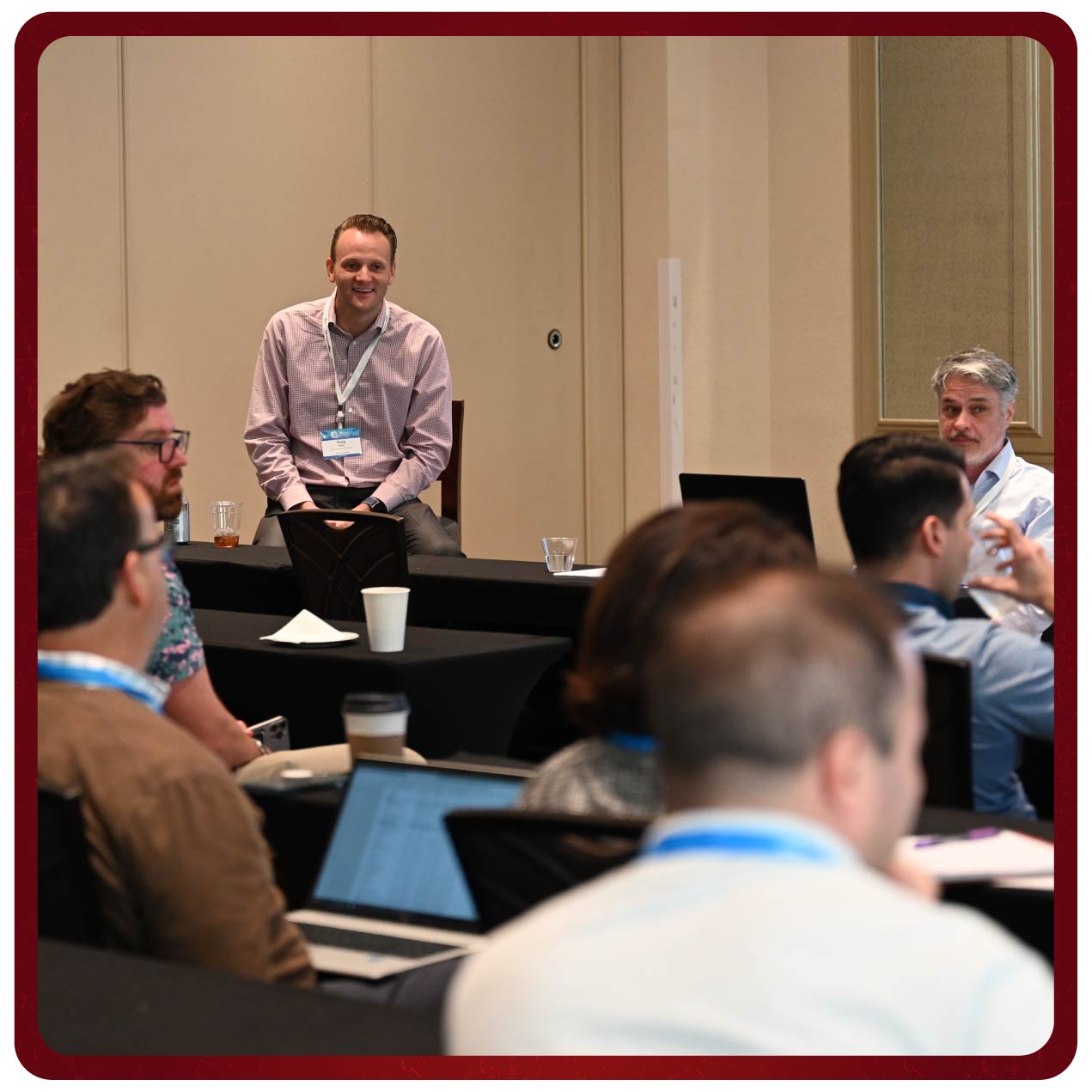 Presenters and attendees smile and laugh during a Rego University class. 