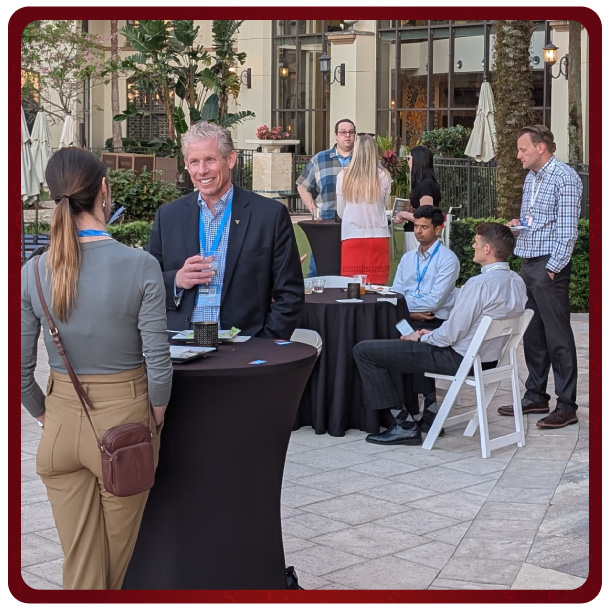 Participants socializing and enjoying food and drinks at the reception