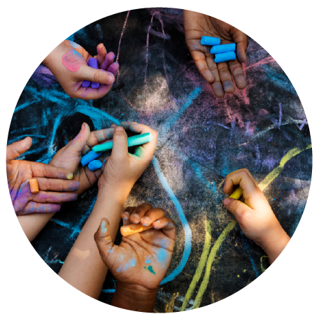 Kid chalk art Children’s hands drawing with colorful chalk on pavement, symbolizing creativity and collaboration.