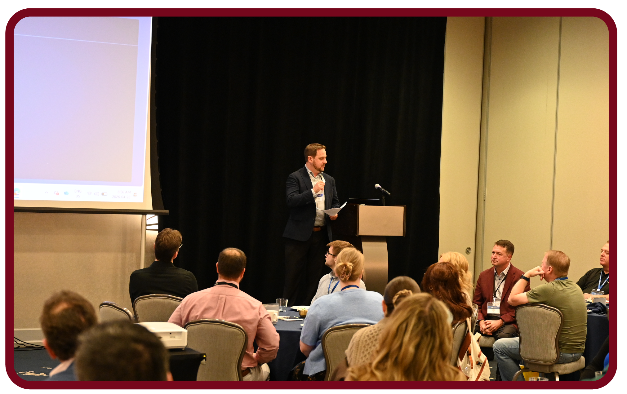 Apptio RegoU Recap-11 Presenter speaks at Rego University while attendees participate in a live conference session and discussion.