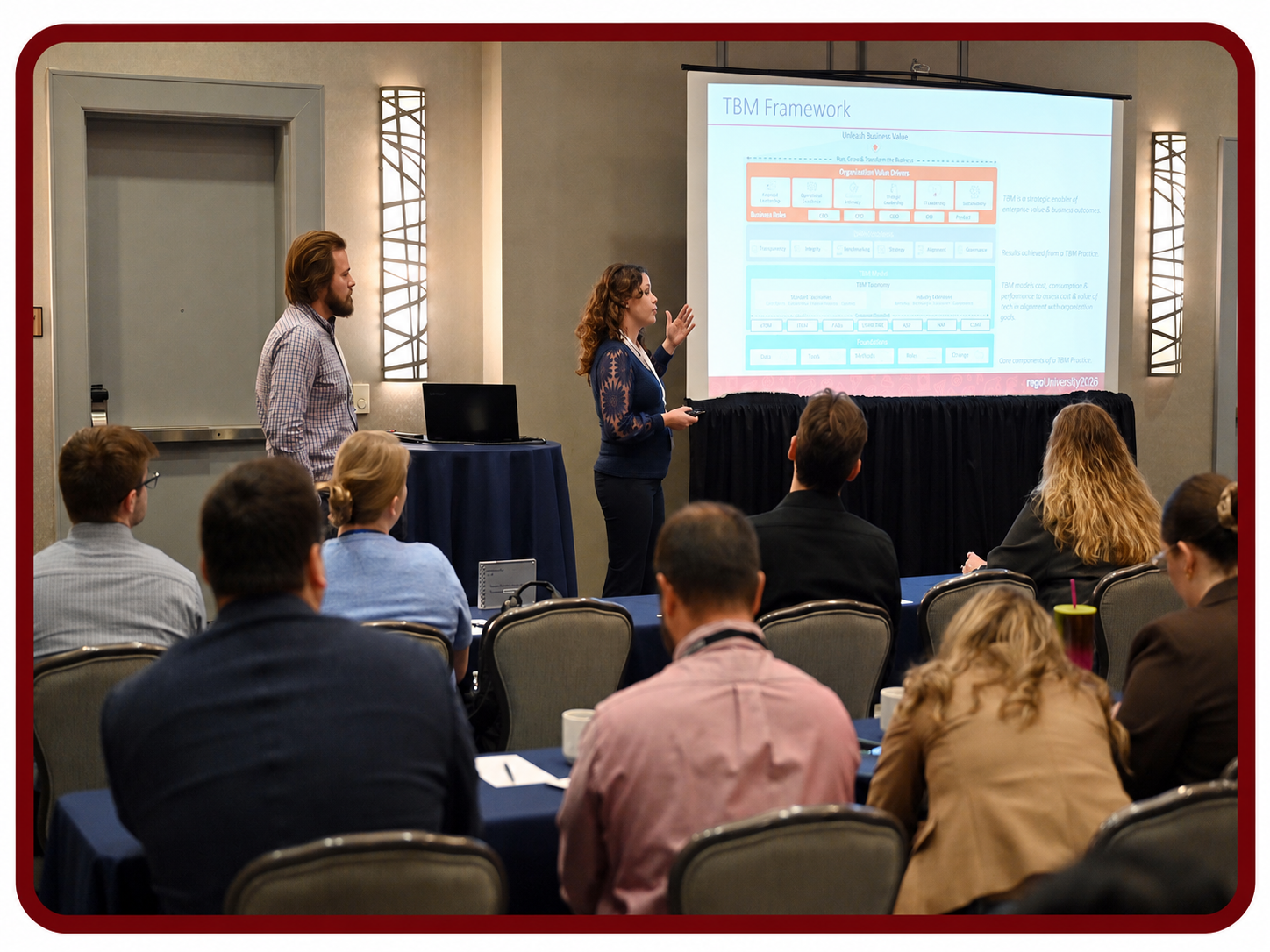 Z62_4445_1 Presenter leads a Rego University session on IBM Apptio framework while attendees watch and take notes.